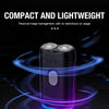 A compact, black electric portable double-head shaver with a purple light glow on a dark background.