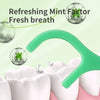A green dental floss pick is shown extracting fresh breath from a white molar tooth.