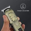A hand holds a gold-toned electric hair clipper with a textured grip and a digital power indicator.