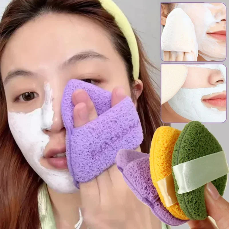 A woman is using a purple exfoliating cleansing sponge on her face for blackhead removal.