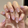 A close-up of a hand displaying 24Pcs Pink Flower Almond press on nails with a sheer pink and nude gradient finish.