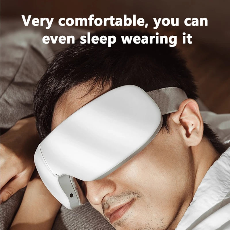 A man is wearing a white smart eye massager while sleeping or relaxing.