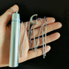 A hand holds a silver reusable aluminum toothpick set with various metal tools for oral cleaning.