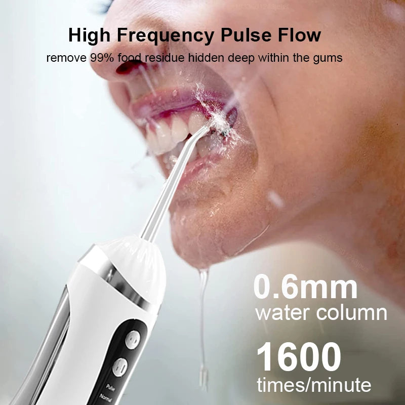 A close-up of a person using a white oral irrigator to clean deep within the gums, showing a water column and flow.