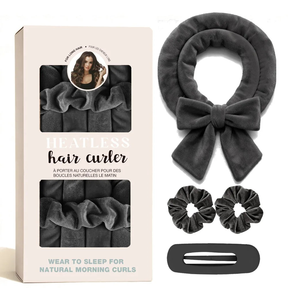 A box containing a velvet heatless hair curler, a bow, and two hair curlers for natural morning curls.