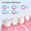 A close-up of a white dental model being cleaned with a precision electric water floss device.