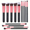 A set of professional makeup brushes in various sizes and shades, including pink and black handles.