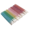 A fan of crystal applicator wands in a gradient of pink, purple, green, and blue.
