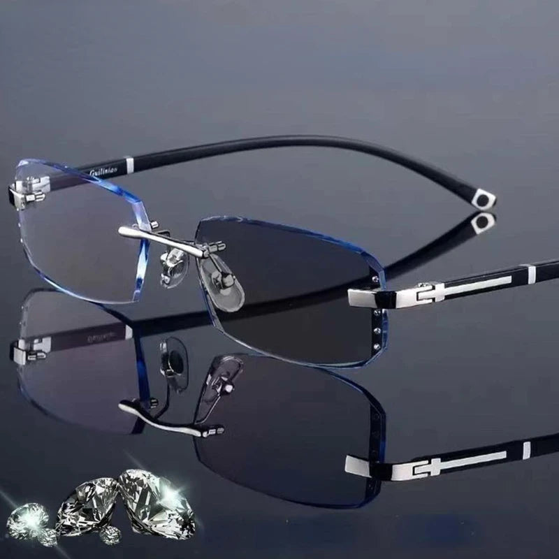 A pair of luxury photochromic reading glasses with dark blue lenses and silver frames resting on a reflective surface.