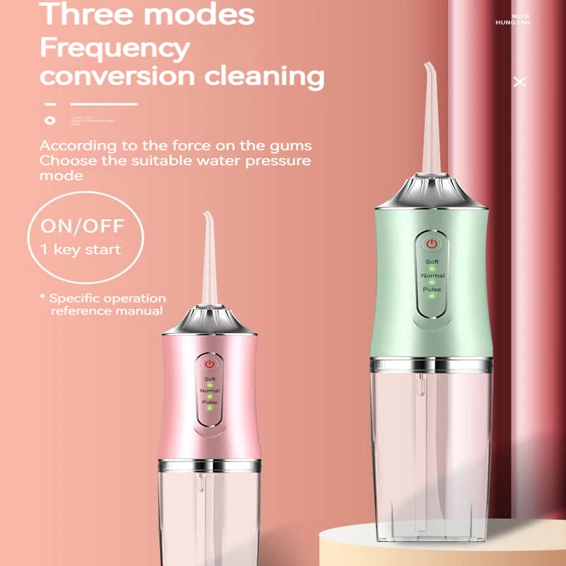A pink and green USB rechargeable dental flosser device is shown on a white surface.