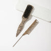 A set of two leopard print pointed tail hair combs displayed on a white surface.