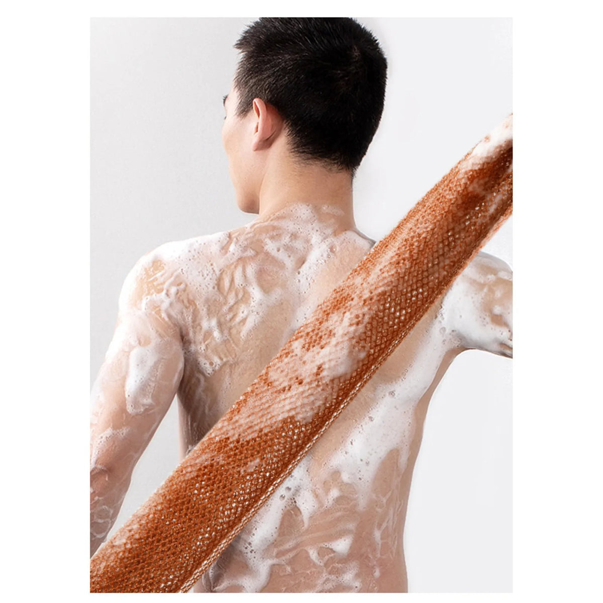 A person is shown with a reusable exfoliating bath sponge washcloth lathered in soap on their back.