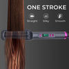 A close-up of a professional electric hair straightener comb applying one stroke to straighten brown hair.