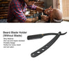 A black blade holder for a straight razor is shown next to a man shaving his head.