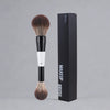A black box containing a dual-ended makeup brush with a brown bristles and white handle.