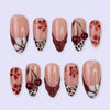 A set of 24 press-on nails featuring a pink and white marbled design with small floral accents.