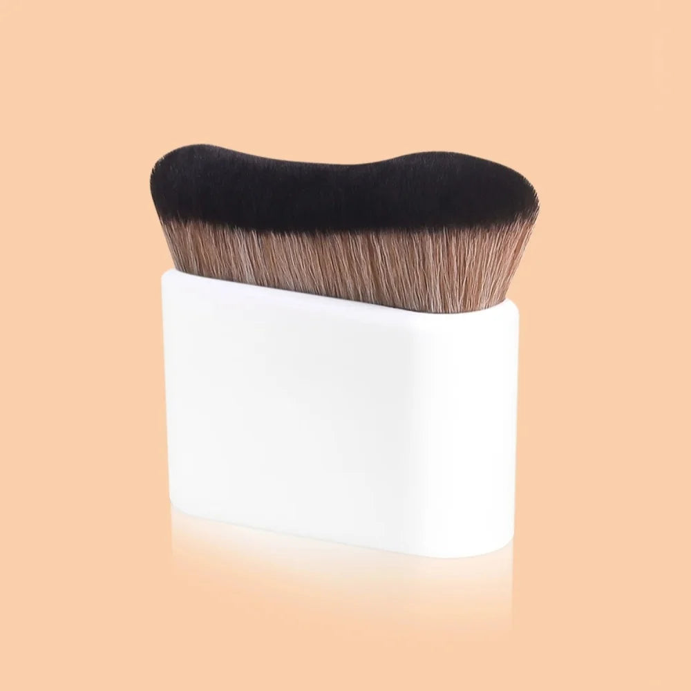 A pro-grade contour foundation brush with angled wavy bristles shown against a light background.