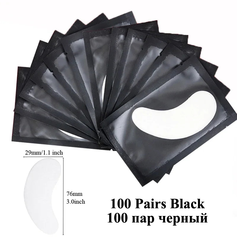 A pack of 100 pairs of black under-eye lash application patches shown in a fan arrangement.