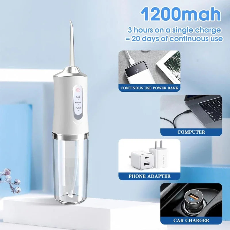 A clear glass water flosser device with a silver top and a white body is displayed on a white surface.