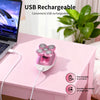 Pink USB rechargeable electric body hair removal shaver resting on a pink table next to a laptop.
