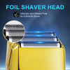 Close-up of a gold electric shaver head with a mesh shaving foil visible.