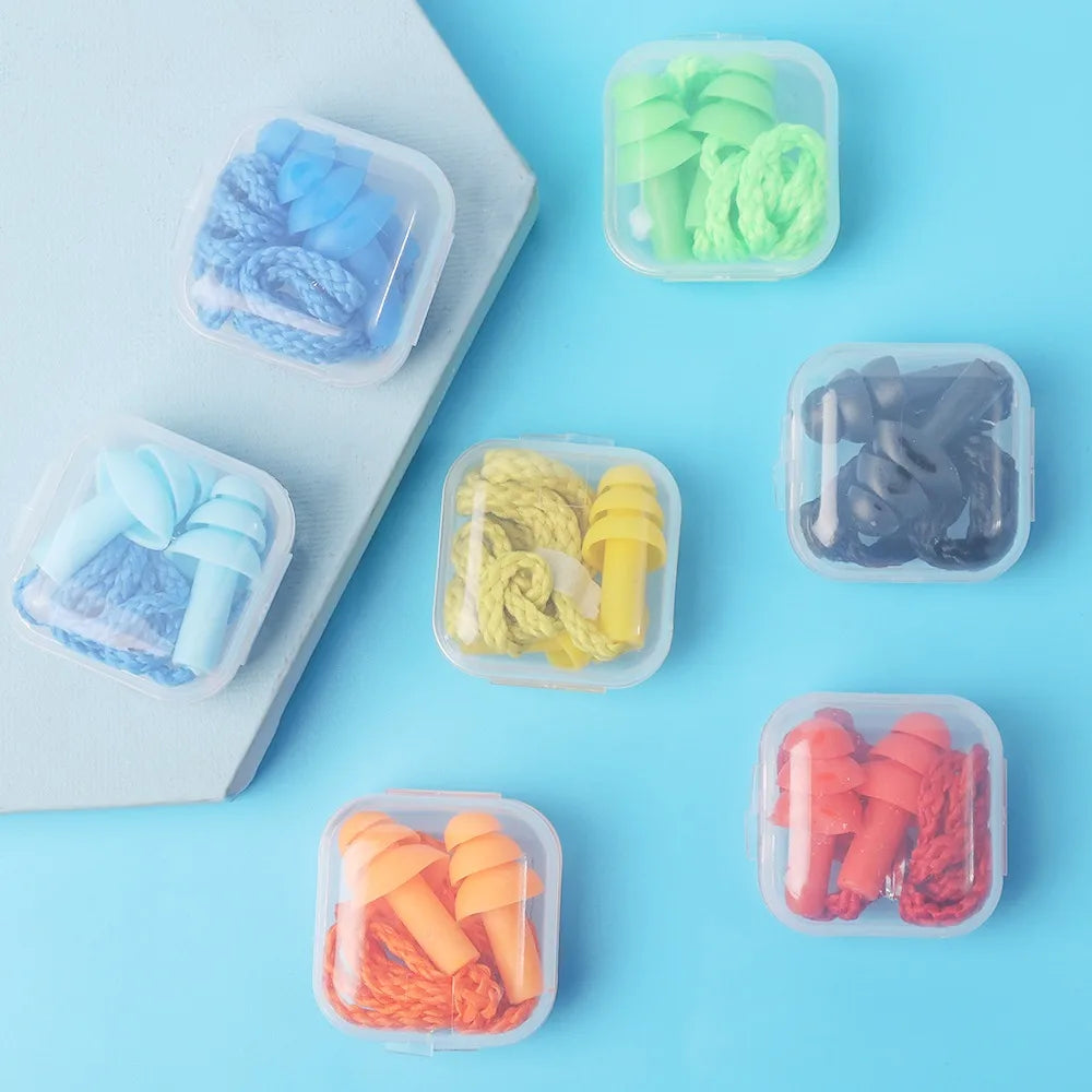 Assortiment de bouchons d'oreille en silicone réutilisables de différentes couleurs, y compris bleu, vert, jaune et orange.