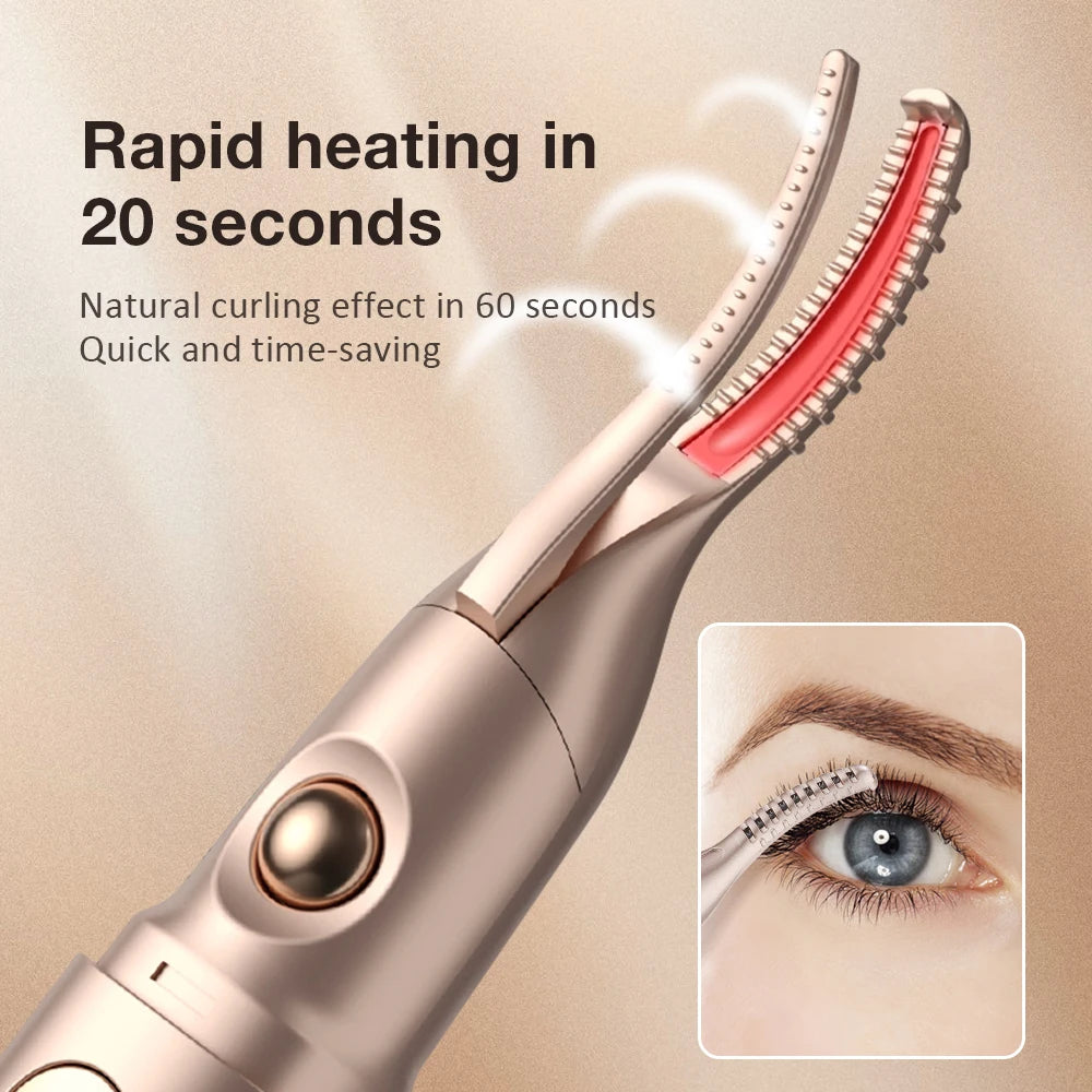 A close-up of a rose gold electric heated eyelash curler and eyebrow trimmer device with a red heating element.