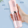 A hand holds a pink portable dental water flosser demonstrating weak, strong, and pulse cleaning modes.