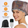 A woman is wearing a shiny metallic hair steamer cap while a black steamer bag and a handheld device are displayed.