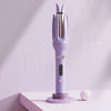A purple automatic ceramic hair curler with a metallic nozzle is displayed on a white surface.