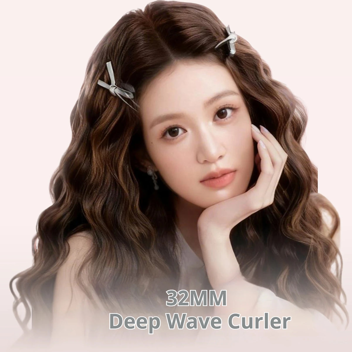Close-up of a woman with long brown wavy hair holding her face, demonstrating the 32MM Deep Wave Curler iron.