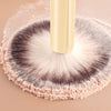 A professional makeup brush set with a light yellow handle and soft, fluffy bristles is shown on a neutral background.
