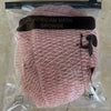 A pink exfoliating net bath sponge is packaged in a clear plastic bag.