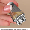 A hand holds a clear precision scalp oil applicator bottle with a ball-tip massager for massage.