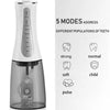A white portable water flosser device with a clear water reservoir and various mode settings displayed.