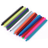 A collection of dental orthodontic elastic ligature ties in various colors, arranged diagonally.