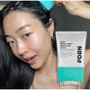 A woman is shown using a PDRN Reedle Shot Brush hair serum product on her scalp.