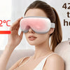 A woman is using a pink heated eye compress device to relieve eye fatigue and relax muscles around the eyes.