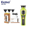 A Kemei KM-999 cordless electric hair clipper with a green body and black components.