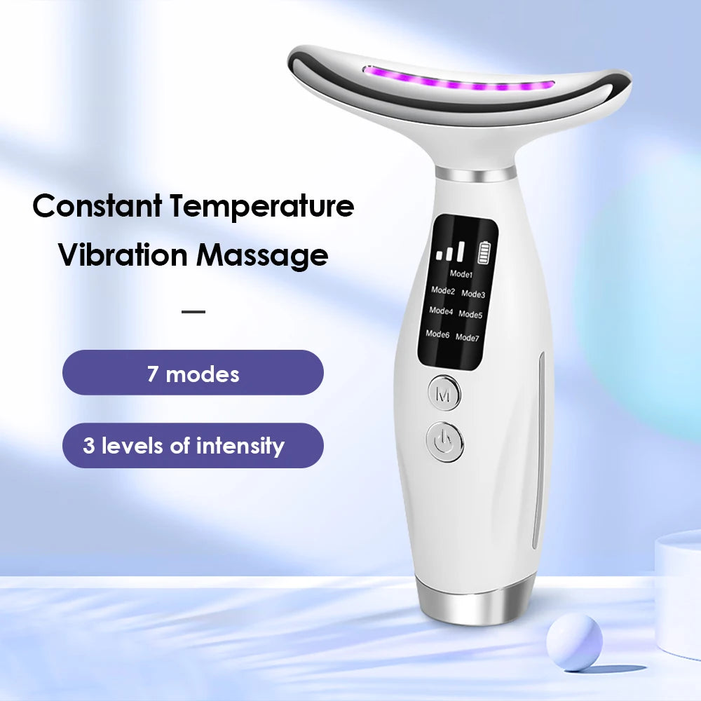 A white beauty and massage device with a glowing LED head is shown on a surface.