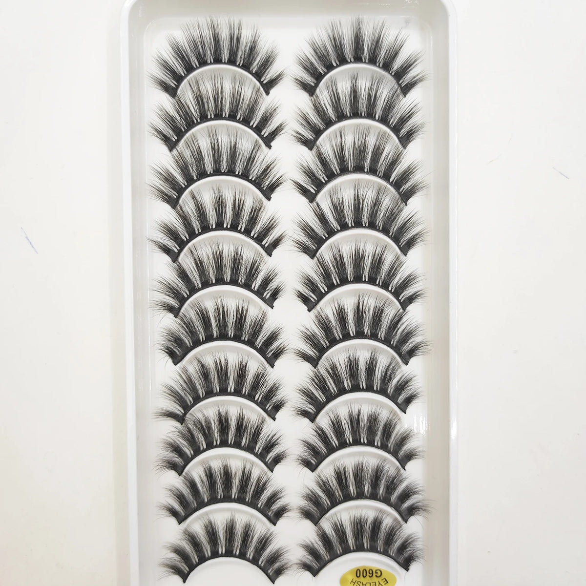 A tray of natural 3D mink false eyelashes displayed for sale.