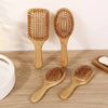 Three wooden bamboo combs for scalp and hair growth, showing different sizes and styles.
