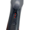 Close-up view of the handle of a black professional heat comb hair straightener with buttons.