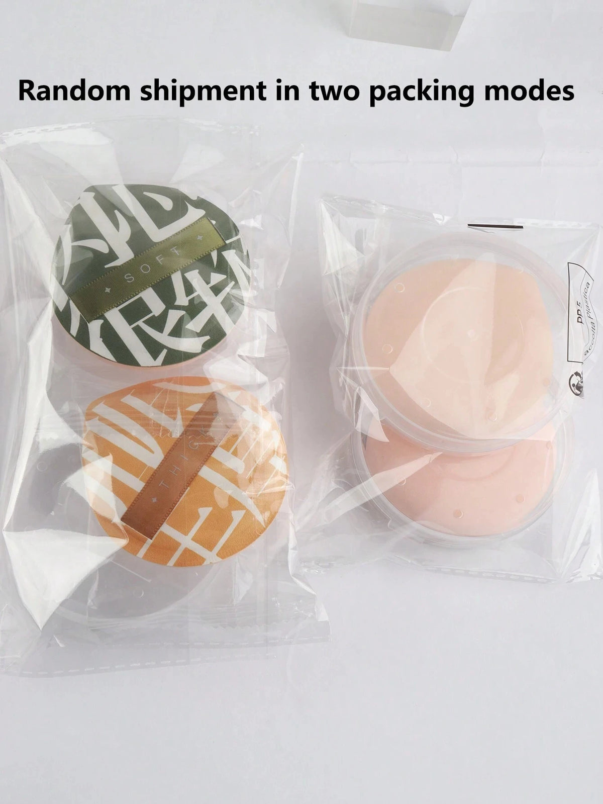 Two packages of soft makeup sponge puffs, one green and one orange, are shown in clear plastic packaging.