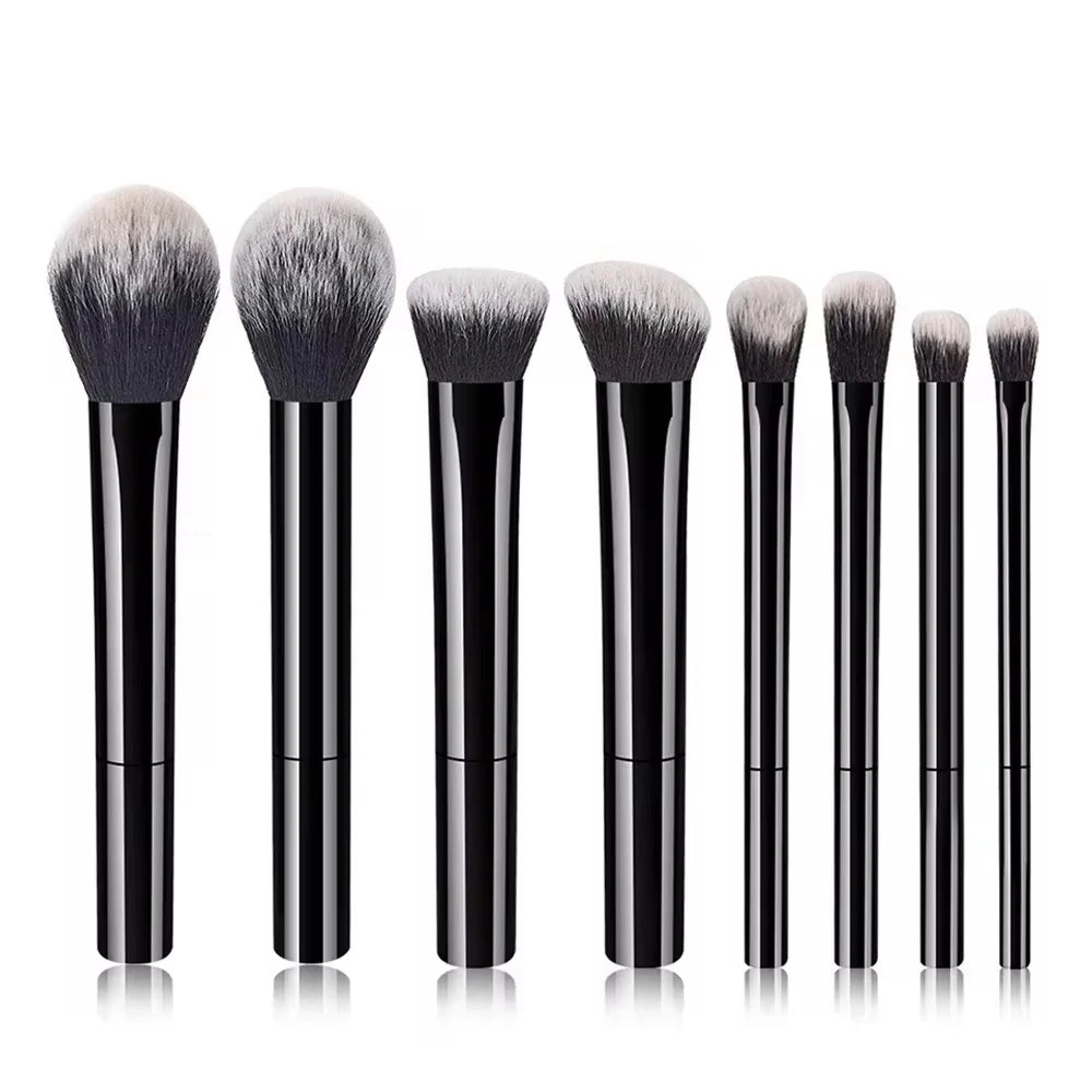 A set of eight black makeup brushes with fluffy synthetic hair displayed vertically.