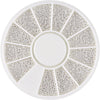 A circular plate with multiple radiating sections of small stainless steel beads for nail art decorations.