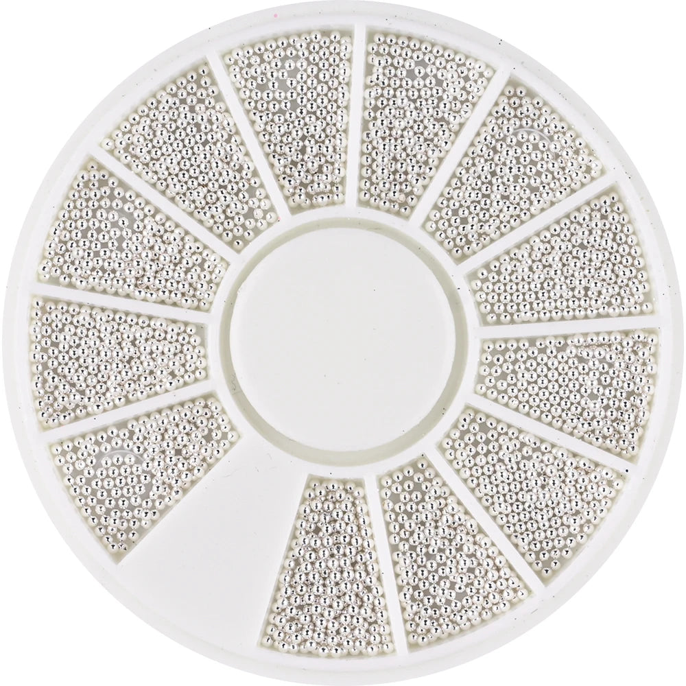 A circular plate with multiple radiating sections of small stainless steel beads for nail art decorations.