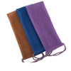 Three exfoliating body scrub sponges in brown, blue, and purple mesh