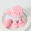 Un ensemble de poudres légères roses avec des bandes roses et des broderies colorées, présentées sur une assiette blanche.