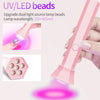 A pink cordless mini UV LED nail lamp bead device with a light beam illuminating a surface.